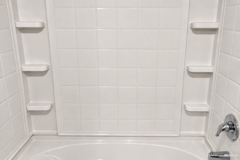 The same tub and shower surround after Pure Space deep cleaning, bright white with clean grout lines