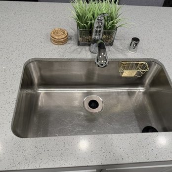 Kitchen sink after Pure Space professional cleaning, empty and polished stainless steel